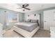 This bedroom features a ceiling fan, light blue walls, carpet and a white-painted furniture set at 6184 Clayton St, Frederick, CO 80530
