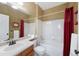 Bright bathroom with shower and tub combination with red curtains and decorative mirror at 10633 Wynspire Way, Highlands Ranch, CO 80130