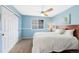 Blue bedroom with a large window and closet at 10633 Wynspire Way, Highlands Ranch, CO 80130