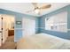 Blue bedroom with a large window and closet at 10633 Wynspire Way, Highlands Ranch, CO 80130