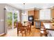 Bright dining area features wood floors, slider to deck, and adjacent kitchen with stainless appliances at 10633 Wynspire Way, Highlands Ranch, CO 80130