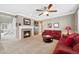 Cozy living room with fireplace, comfortable seating and natural light from the windows at 10633 Wynspire Way, Highlands Ranch, CO 80130