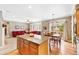 Open concept living room flows from kitchen, hardwood floors, and backyard patio access at 10633 Wynspire Way, Highlands Ranch, CO 80130