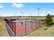 Outdoor tennis courts, surrounded by black fencing and grassy open space under a blue sky at 10633 Wynspire Way, Highlands Ranch, CO 80130