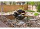A soothing rock waterfall feature with water cascading into a serene pond with decorative rocks at 10633 Wynspire Way, Highlands Ranch, CO 80130