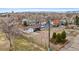 Aerial view of a home surrounded by trees and other colorful houses, offering a unique perspective of the property at 11640 W 13Th Ave, Lakewood, CO 80401