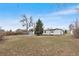 Backyard view of property featuring a large lot with mature trees and a detached shed at 11640 W 13Th Ave, Lakewood, CO 80401