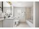 Well-lit bathroom with modern vanity, tile accents, and a bathtub at 11640 W 13Th Ave, Lakewood, CO 80401