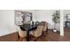 Elegant dining room featuring a sleek black table, wicker chairs, and decorative wall art at 11640 W 13Th Ave, Lakewood, CO 80401