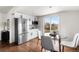 Bright eat-in kitchen featuring stainless steel appliances, white cabinetry, and a glass sliding door at 11640 W 13Th Ave, Lakewood, CO 80401