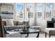 Inviting living room showcasing a gray sofa with decorative pillows, a glass coffee table, and a window view at 11640 W 13Th Ave, Lakewood, CO 80401