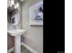 Sleek bathroom features a pedestal sink, modern faucet, and elegant mirror at 1200 Sugarloaf Ln, Erie, CO 80516