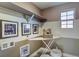 Functional laundry room with storage shelves, ironing board and decor with laundry themed decorations at 1200 Sugarloaf Ln, Erie, CO 80516