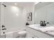 Modern bathroom featuring a clean, white aesthetic, updated fixtures, and a stylish vanity at 15282 W 69Th Pl, Arvada, CO 80007
