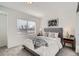 Cozy bedroom with a comfortable bed, soft lighting, and a view from the window at 15282 W 69Th Pl, Arvada, CO 80007
