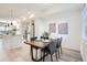 Elegant dining area with a modern table setting, adjacent to a well-equipped kitchen at 15282 W 69Th Pl, Arvada, CO 80007
