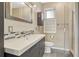 Modern bathroom with a neutral color palette, tiled backsplash, and a glass shower door at 980 S Locust St # D, Denver, CO 80224