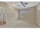 Bedroom with carpet, ceiling fan, and multiple closets, offering ample storage space at 980 S Locust St # D, Denver, CO 80224