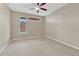Bright bedroom with neutral carpet, a ceiling fan, and natural light from window at 980 S Locust St # D, Denver, CO 80224
