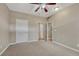 Bedroom featuring carpet, a ceiling fan, closet space, and an en suite bathroom at 980 S Locust St # D, Denver, CO 80224