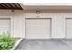 Garage door featuring a neutral color, panel design, and driveway at 980 S Locust St # D, Denver, CO 80224