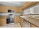 Updated kitchen with stainless steel appliances and tile backsplash at 980 S Locust St # D, Denver, CO 80224