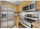 Modern kitchen with stainless steel appliances, range, and refrigerator at 980 S Locust St # D, Denver, CO 80224