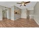 Open-concept living area with hardwood floors, ceiling fan, and a view of the kitchen at 980 S Locust St # D, Denver, CO 80224