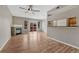 Bright living room featuring hardwood floors, a stone fireplace, and sliding doors to a balcony at 980 S Locust St # D, Denver, CO 80224