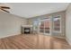 Spacious living room with hardwood floors, fireplace, and sliding glass doors leading to the balcony at 980 S Locust St # D, Denver, CO 80224