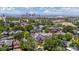 Scenic aerial view showcases a neighborhood with green trees and a captivating skyline backdrop at 1365 Clayton St, Denver, CO 80206