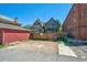 Backyard area featuring a wood fence, parking area, and trash bins at 1365 Clayton St, Denver, CO 80206