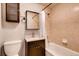 Cozy bathroom featuring tiled walls, a granite countertop, and a shower-tub combo at 1365 Clayton St, Denver, CO 80206