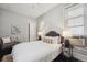 Cozy bedroom featuring white walls, a grey headboard, and window blinds at 1365 Clayton St, Denver, CO 80206
