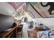 Attic bedroom featuring a sloped ceiling, vintage desk, and charming eclectic decor at 1365 Clayton St, Denver, CO 80206