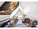 Attic bedroom featuring sloped ceilings, a window, and a drum set at 1365 Clayton St, Denver, CO 80206
