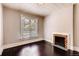 Cozy bedroom with hardwood floors, bright window, and a decorative fireplace at 1365 Clayton St, Denver, CO 80206