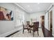Bright dining room featuring stylish chairs, a decorative rug, natural light, and easy access to other living spaces at 1365 Clayton St, Denver, CO 80206
