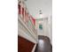 Elegant entryway featuring a staircase with white banisters, hardwood floors, and a bright, welcoming ambiance at 1365 Clayton St, Denver, CO 80206