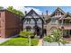 Stylish two-story home boasts a classic facade, complete with manicured lawn, and inviting curb appeal at 1365 Clayton St, Denver, CO 80206