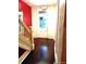 Bright hallway with dark wood floors, painted walls and decorative banister at 1365 Clayton St, Denver, CO 80206