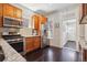 Charming kitchen with stainless steel appliances, granite countertops, and dark hardwood flooring at 1365 Clayton St, Denver, CO 80206