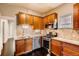 Modern kitchen featuring stainless steel appliances, granite countertops, and rich wood cabinetry at 1365 Clayton St, Denver, CO 80206