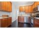 Well-equipped kitchen with stainless steel appliances, wooden cabinets, and granite countertops at 1365 Clayton St, Denver, CO 80206