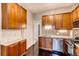 Bright kitchen featuring wood cabinets, granite countertops, and stainless steel appliances at 1365 Clayton St, Denver, CO 80206