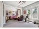 The room includes a ceiling fan, multiple windows, artwork, sofa, and chair at 1365 Clayton St, Denver, CO 80206