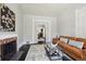 Inviting living room featuring a fireplace, comfortable seating, stylish decor, and easy access to other living spaces at 1365 Clayton St, Denver, CO 80206