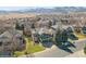 Scenic neighborhood shot with lush lawns, mature trees, and stunning mountain views in the background at 2829 S Fig St, Lakewood, CO 80228