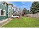 A well maintained backyard including a spacious grassy area at 2829 S Fig St, Lakewood, CO 80228