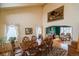 Elegant dining room featuring a large table, decorative tapestry, and an archway leading to a cozy sitting area at 2829 S Fig St, Lakewood, CO 80228